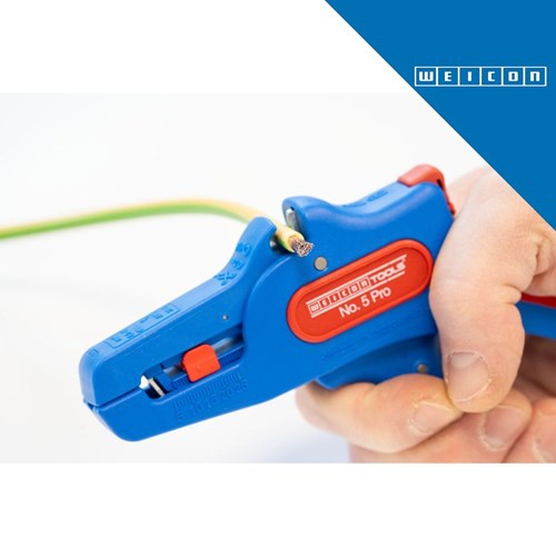 Ruka drži plavi WEICON Wire Stripper No.5 Pro, alat za odvajanje izolacije žica, s crvenim detaljima i zelenom žicom u pozadini.
